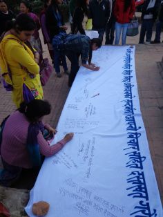 The public writing words in support of women fighting against violence and injustice at one of Prerana's events.